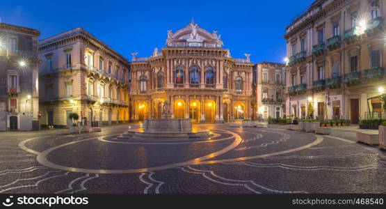 Panoramic view of Piazza Vincenzo Bellini and opera house grandiose theater Massimo Bellini in Sicilian Baroque style in the night lighting, Catania, Sicily, Italy. Theater Massimo Bellini, Catania, Sicily, Italy