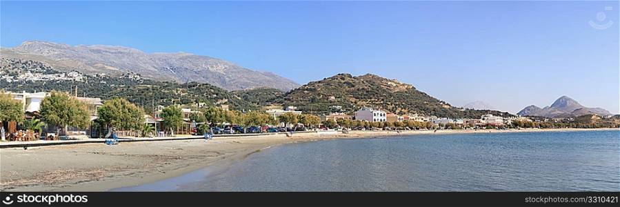 Panoramic view of Plakias tourist resort on the south coast of Crete, Greece, with Myrthios village on the hill to the left.