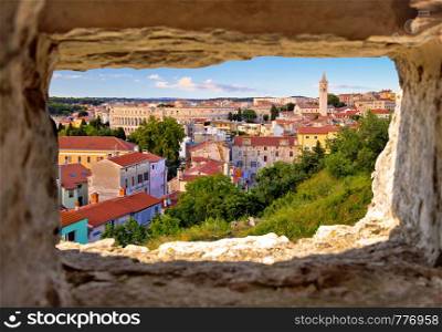 Panoramic view of Pula landmarks through stone window, Istria region of Croatia