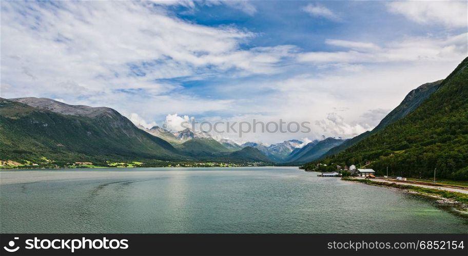 Panoramic view of Romsdalsfjorden and mountains from Andalsnes in Norway under a sunny sky. Panoramic view of Romsdalsfjorden and mountains in Norway