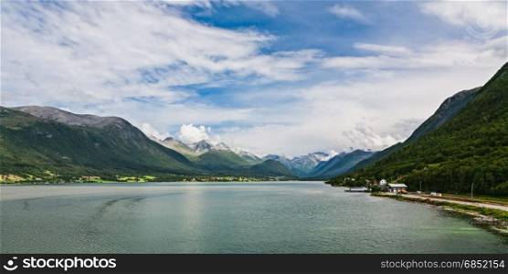 Panoramic view of Romsdalsfjorden and mountains from Andalsnes in Norway under a sunny sky. Panoramic view of Romsdalsfjorden and mountains in Norway