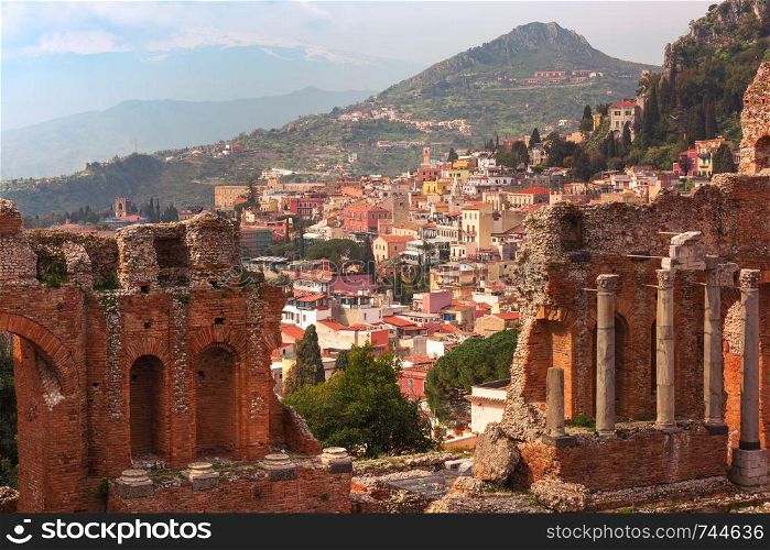 Panoramic view of Ruins of Ancient Greek theatre and Old Town of Taormina in sunny day, Sicily, Italy. Aerial view of Taormina, Sicily, Italy