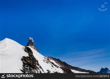 Panoramic view of Sphinx Observation deck tower on Jungfrau top of Europe, snow mountain peak of Switzerland