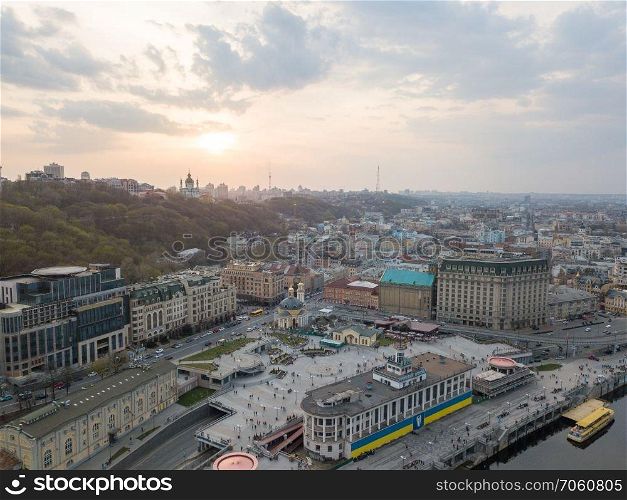 Panoramic view of St. Andrew&rsquo;s Church on the Andreev Mountain and the Ministry of the Interior and the Postal Square with St. Elijah Church in Kiev, Ukraine. Photo by drone. From the bird&rsquo;s eye view of the river station, Postal Square with St. Elijah Church , tourist boats and the Andreev Church on the hill in city Kiev, Ukraine.