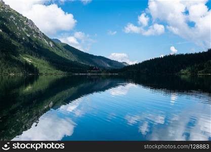 Panoramic view of summer alpine mountain lake. Morskie Oko, Tatra Mountains, Poland. Panoramic view of summer alpine mountain lake