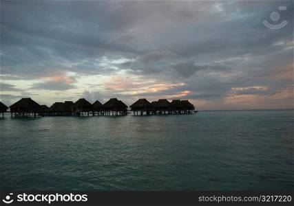 Panoramic view of thatched buildings on stilts in the sea, Moorea, Tahiti, French Polynesia, South Pacific
