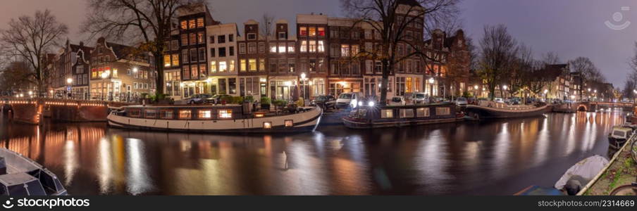 Panoramic view of the city embankment and the facades of houses in the fog on the Amstel canal. Amsterdam. Netherlands.. Panorama of the city waterfront of Amsterdam on a foggy morning.