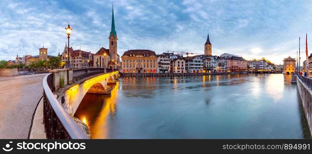 Panoramic view of the city promenade and the facades of medieval houses at dawn. Zurich. Switzerland.. Zurich. Scenic view of the city and the embankment at dawn.