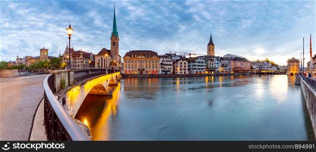 Panoramic view of the city promenade and the facades of medieval houses at dawn. Zurich. Switzerland.. Zurich. Scenic view of the city and the embankment at dawn.
