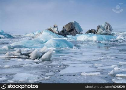 Panoramic view of the glacier lagoon Joekulsarlon with icebergs and in the background the glacier, winter in Iceland, Europe