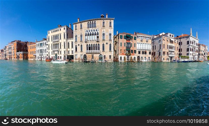 Panoramic view of the grand canal and the facades of medieval houses on a sunny day. Venice. Italy.. Venice. Panorama of the Grand Canal.