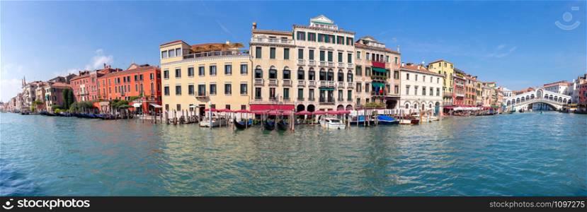 Panoramic view of the grand canal and the facades of medieval houses on a sunny day. Venice. Italy.. Venice. Panorama of the Grand Canal.