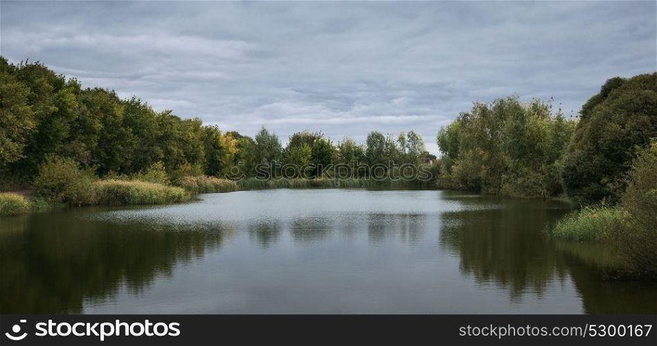 Panoramic view of the lake in the park in autumn
