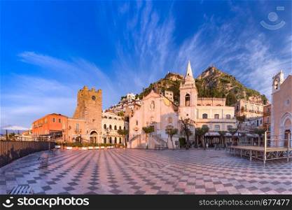 Panoramic view of the morning square Piazza IX Aprile with San Giuseppe church, the Clock Tower and Mount Etna Volcano on background, Taormina, Sicily, Italy. Piazza IX Aprile, Taormina, Sicily, Italy