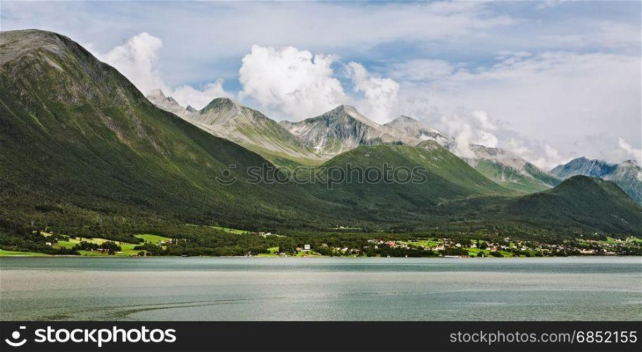 Panoramic view of the mountains along the Romsdalsfjorden in Norway under a sunny sky. Panoramic view of the mountains along the Romsdalsfjorden in Norway