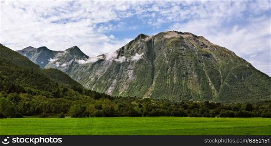 Panoramic view of the mountains near Andalsnes in Norway under a cloudy sky. Panoramic view of the mountains near Andalsnes in Norway