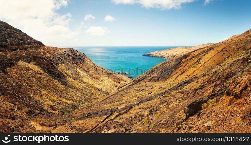 Panoramic view of the ocean bay and desert valley. Little bay in the mountains