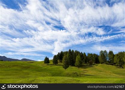 panoramic view of the Seiser Alm in a sunny day with blue sky and clouds
