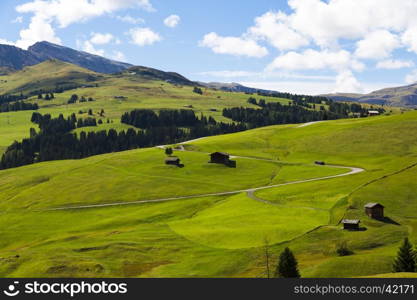 panoramic view of the Seiser Alm in a sunny day with blue sky and clouds