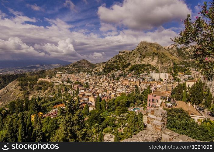 Panoramic view of the sicilian territory and the sicilian city of taormina and the vegetation and mountains that surround it