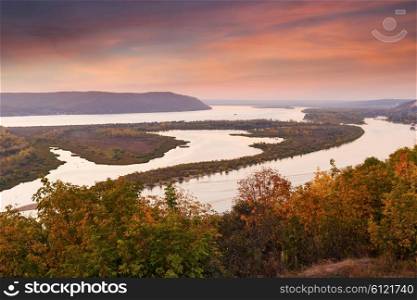 Panoramic view of the valley of the river from the hill at sunset