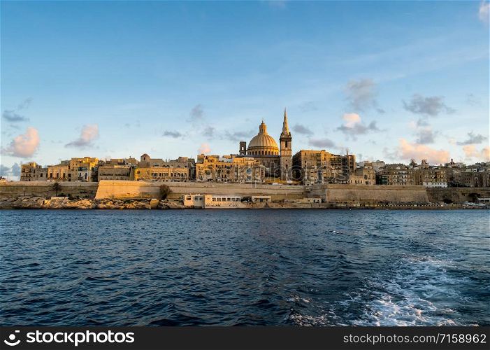 Panoramic view of Valletta Skyline at beautiful sunset from Sliema with churches of Our Lady of Mount Carmel and St. Paul&rsquo;s Anglican Pro-Cathedral, Valletta, Capital city of Malta