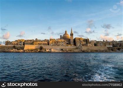 Panoramic view of Valletta Skyline at beautiful sunset from Sliema with churches of Our Lady of Mount Carmel and St. Paul&rsquo;s Anglican Pro-Cathedral, Valletta, Capital city of Malta