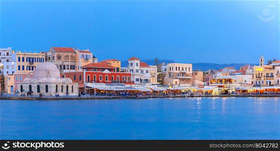 Panoramic view of Venetian quay of Chania with Kucuk Hasan Pasha Mosque during twilight blue hour, Crete, Greece