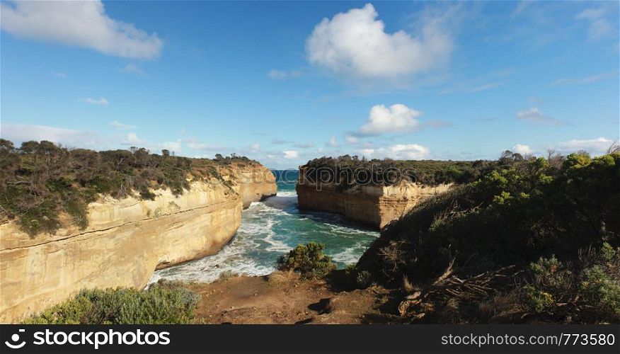 panoramic view of wild winter waves crashing into Loch Ard gorge, famous site of a shipwreck, great ocean road, Southern Victoria, Australia.