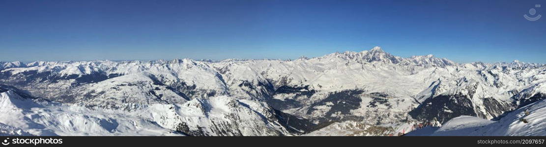 panoramic view on peak mountain range covered with snow and under blue sky in Tarentaise, Savoie