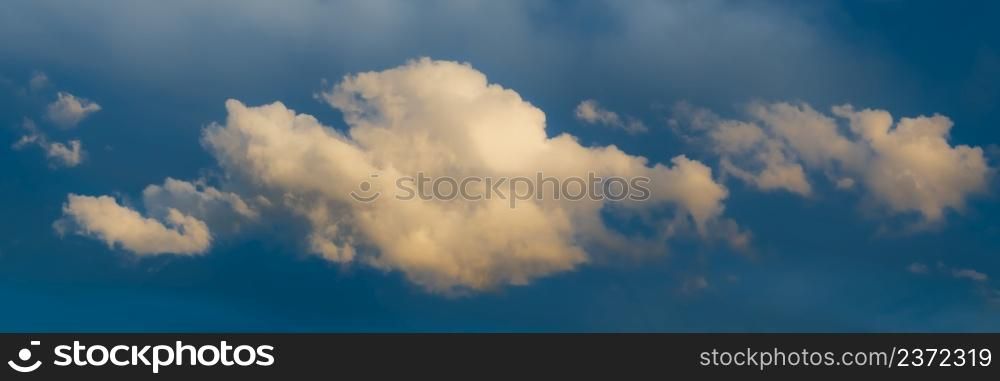Panoramic view on Sky with dramatic fluffy clouds. White clouds on the sky suitable for background. Cloudy sky. Overcast. Long panoramic Banner. Panoramic view on Sky with dramatic fluffy clouds. White clouds on the sky suitable for background. Cloudy sky. Overcast. Long panoramic Banner.