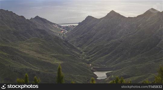 panoramic view over a small part of the Anaga mountain range with a village and ocean in the back, Tenerife, Canary Islands, Spain