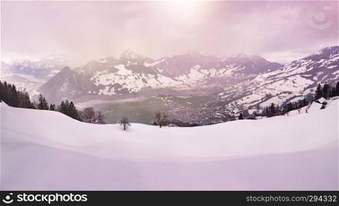 panoramic view over the swiss alps in winter during sunset