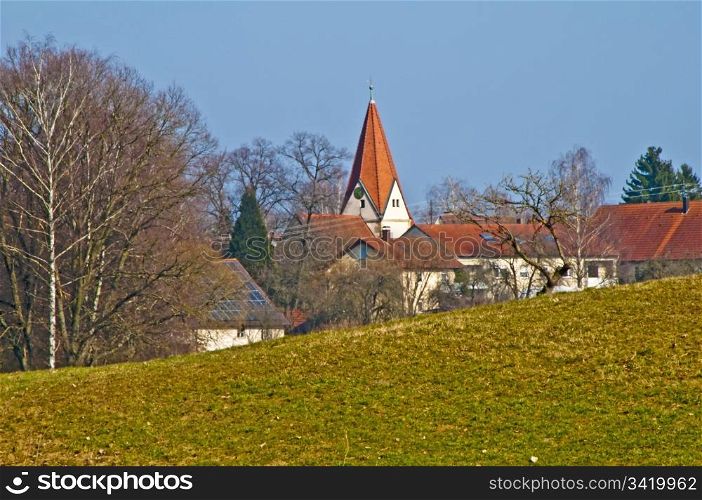 panoramic view to a small village with a church. country