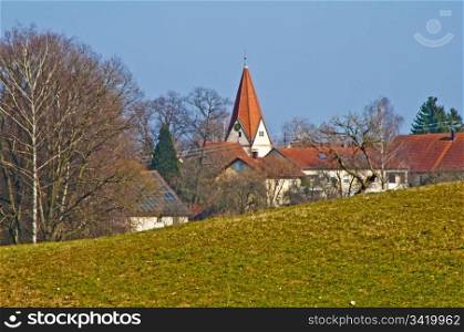 panoramic view to a small village with a church. country