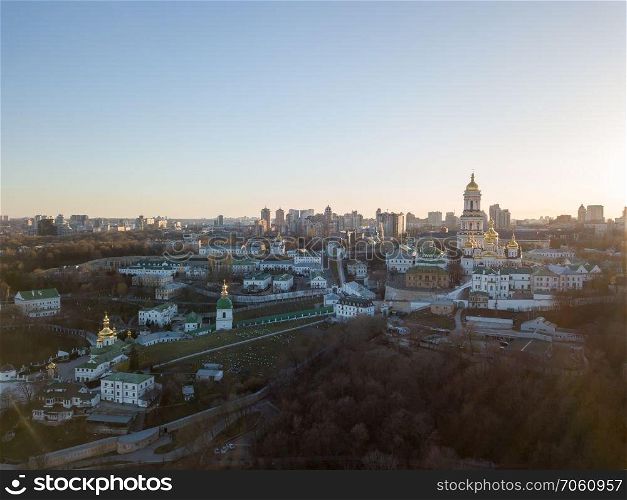 Panoramic view to historical famous places the Pechersk Lavra - most ancient monument of UNESCO, in Kiev, Ukraine at sunset in the summer. Panoramic photography from the drone.. Bird&rsquo;s eye view from the drone to the Kiev Pechersk Lavra with historical cathedral of the monastery in Kiev, Ukraine.