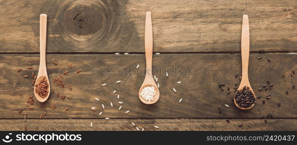 panoramic view wooden spoon with white brown rice wooden table