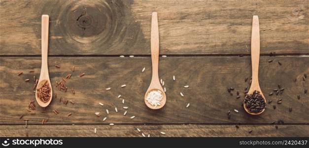 panoramic view wooden spoon with white brown rice wooden table
