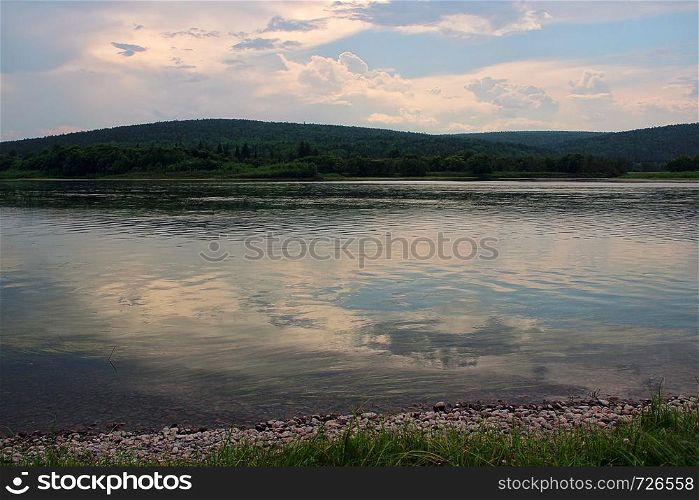 Panoramic views on the river in Siberia during a warm summer evening.