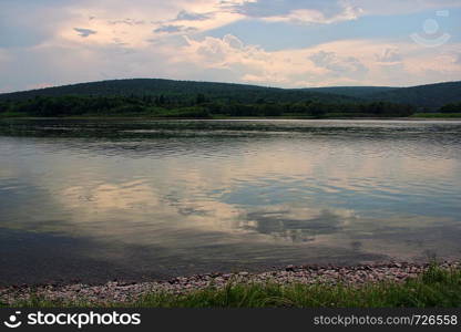 Panoramic views on the river in Siberia during a warm summer evening.