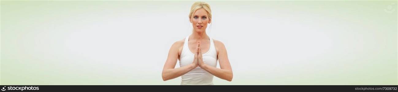 Panoramic web banner beautiful woman young female hands in prayer practicing yoga postion indoors at a gym or health spa