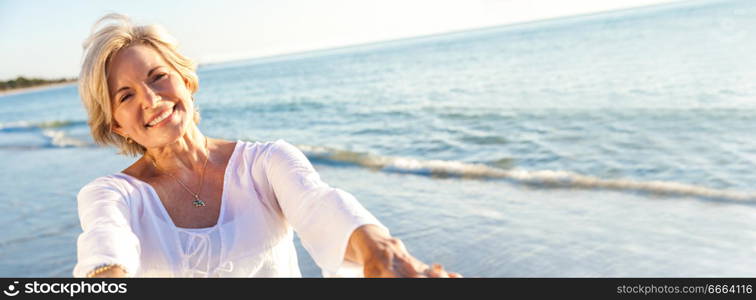 Panoramic web banner happy senior woman dancing and reaching with her hands on a deserted tropical beach