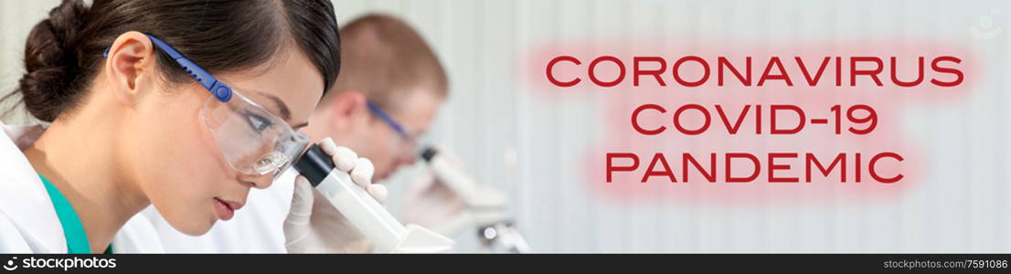 Panoramic web banner of Chinese Asian female woman scientist researcher or doctor using a microscope in a medical research lab or laboratory with her male colleague out of focus behind her and with Coronavirus Covid-19 Pandemic text