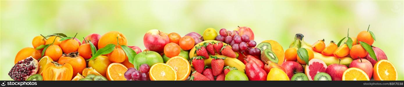Panoramic wide photo of fresh fruits for skinali on a blurred green background.