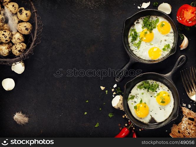 Pans with fried eggs, tomatoes and bread on old metal background, top view. Food. Breakfast. Healthy food.