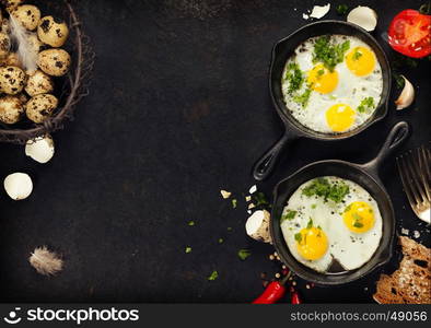 Pans with fried eggs, tomatoes and bread on old metal background, top view. Food. Breakfast. Healthy food.