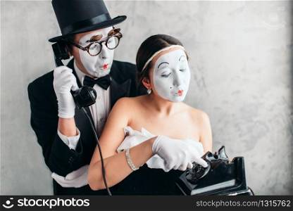 Pantomime theater actor and actress performing. Mime artists with white makeup masks on faces. Pantomime theater actor and actress performing