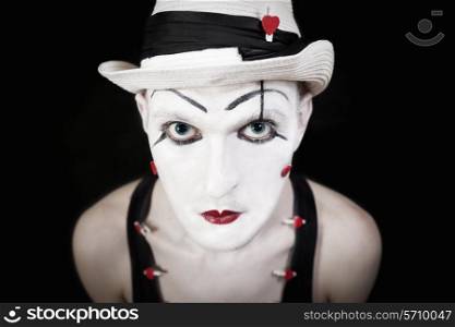 Pantomimes in white hat on black background