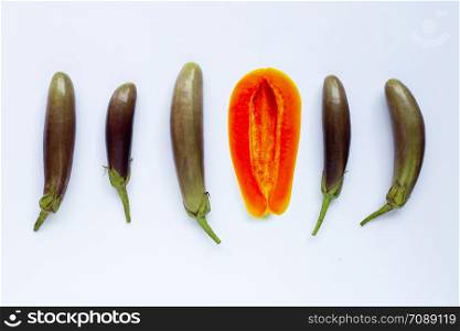 papaya fruit with eggplants on white background. Sex concept, Top view
