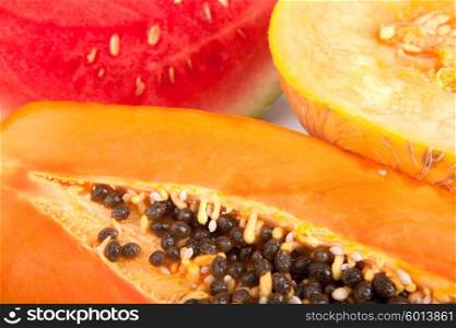 Papaya, melon and watermelon slices isolated over white